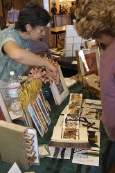 Barbara Correia of Badico Designs talks about her prints and handmade books with a visitor