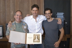 Bookbinder Don Drake, Writer Joshua Brandt and Designer Ophir show off one of the books sold by Joshua's company, A Moment in Time