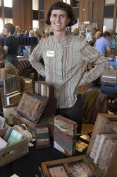 Artist Jody Alexander poses with some of her handmade books and sculptural books
