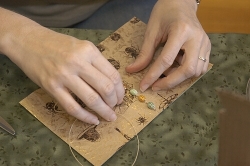 Book Artist Kara Sjoblom-Bay demonstrates a variation on a chain stitch pamphlet binding Book Artist Kara Sjoblom-Bay demonstrates a variation on a chain stitch pamphlet binding