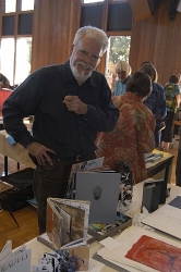 Larry -- of Poor Hedgehog Press mans his table