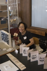 Artist Penny Nii with some of her one of a kind books