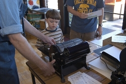 A budding printer learns about the Multigraph press from a member of the San Jose Printer's Guild