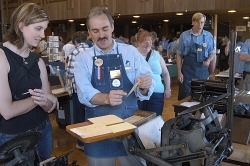Jim Gard of the Printer's Guild at History Park, San Jose, shows a visitor a card created on one of the Guild's letterpresses Jim Gard of the Printer's Guild at History Park, San Jose, shows a visitor a card created on one of the Guild's letterpresses
