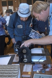 Dave Robison of the Printer's Guild at History Park, San Jose, instructs a visitor in the operation of a Multigraph press