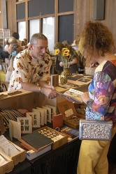 Artist Stephen Sloan shares his work with an art lover Artist Stephen Sloan shares his work with an art lover