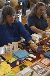 Artist c.j. grossman and friend show off a few of c.j.'s handmade books