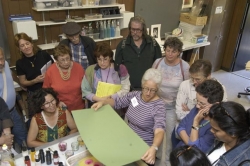 Debbie Kogan demonstrating marbeling, hold the paper over the paint.