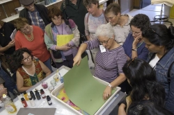 Debbie Kogan demonstrating marbeling, apply paper to paint